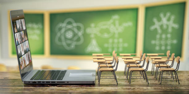 Online education and e-learning concept. Home quarantine distance learning. Laptop and school desks on black desk in classroom